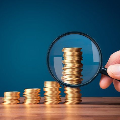 Stacks of coins examined with magnifying glass