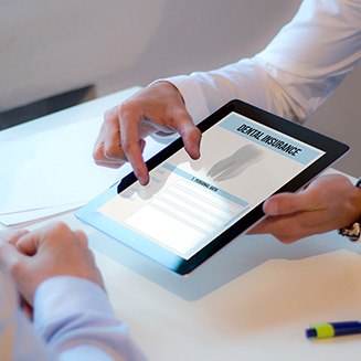 Patient reviewing dental insurance form in office