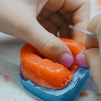 Working on wax mold of gums