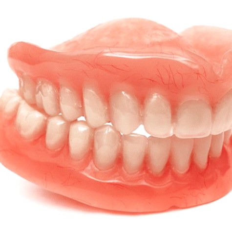 Full upper and lower dentures pictured against white background