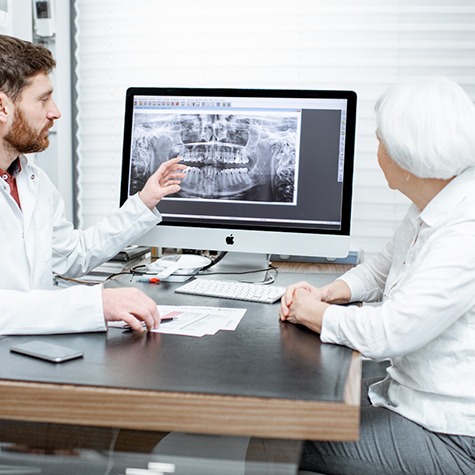 Dentist discussing the cost of tooth extractions in Fulshear