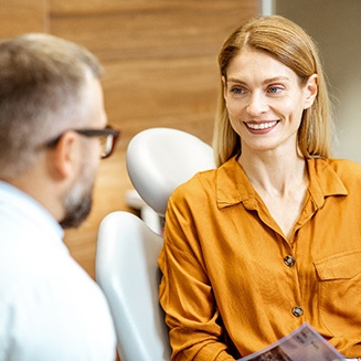 Dentist explaining factors associated with tooth extraction