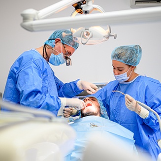 Dentists performing a dental implant surgery