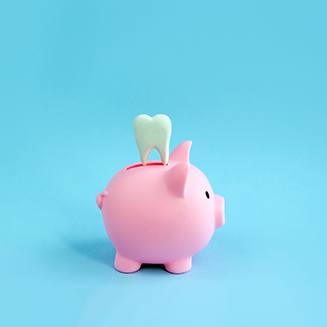 A piggy bank and a decorative tooth on a blue background